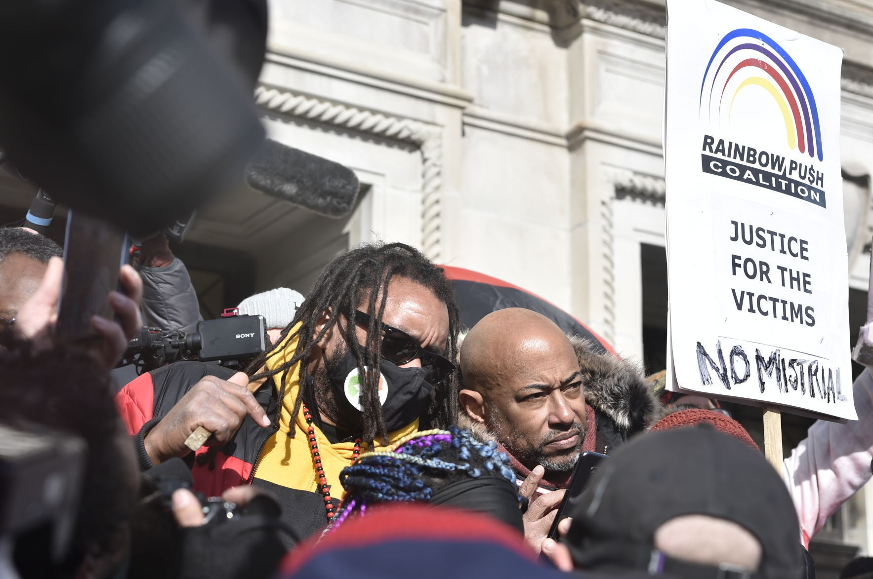 At right, Justin Blake and Bishop Tavis Grant listen to Rittenhouse verdicts